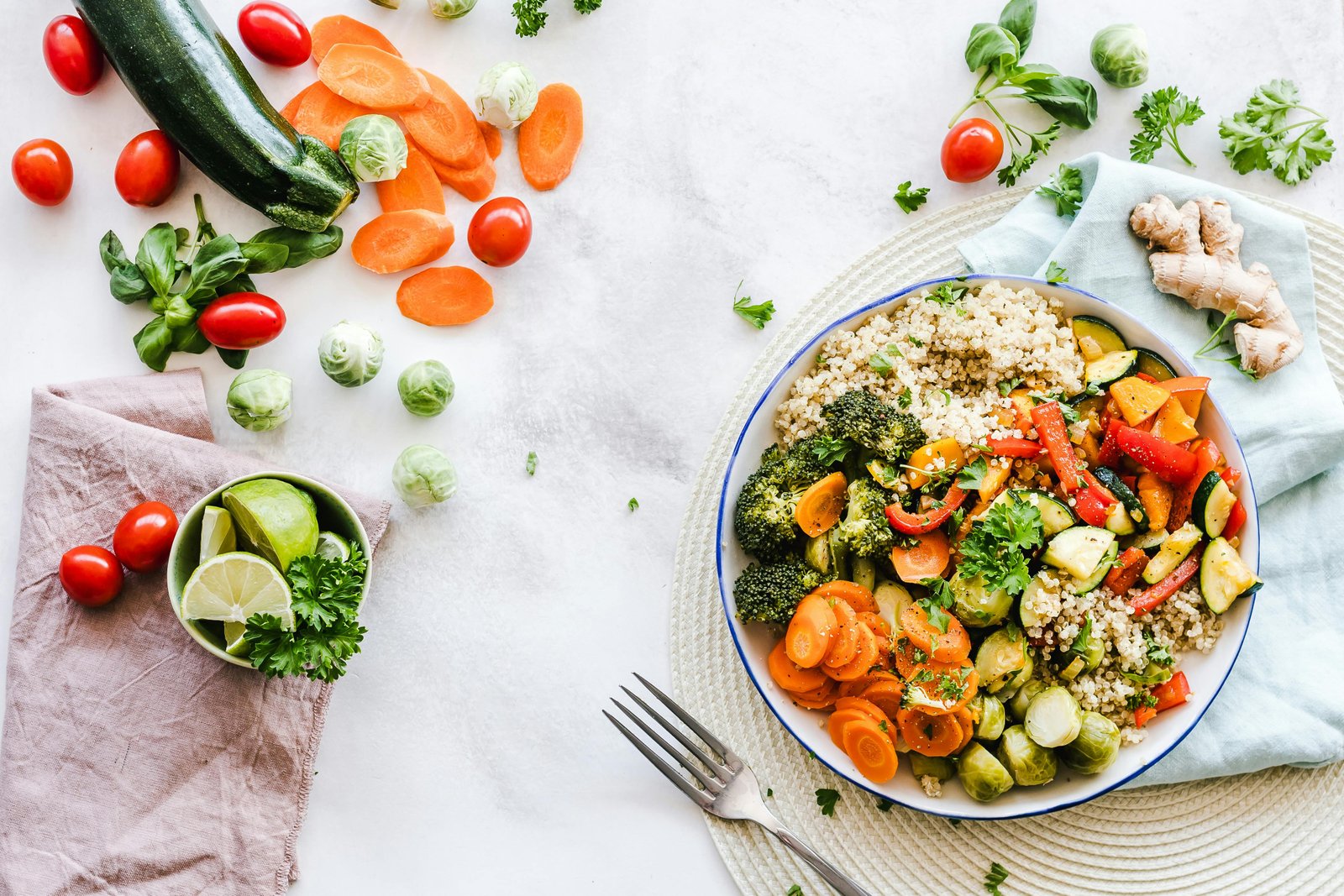 Healthy meal and fresh vegetables arranged on a table